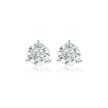 A pair of round lab grown diamond stud earrings with white gold prongs. 