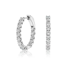 Side view of lab grown diamond hoop earrings set in white gold. 