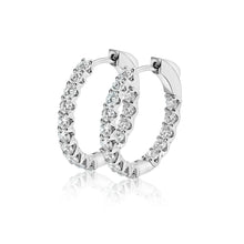 Side view of lab grown diamond hoop earrings set in white gold. 