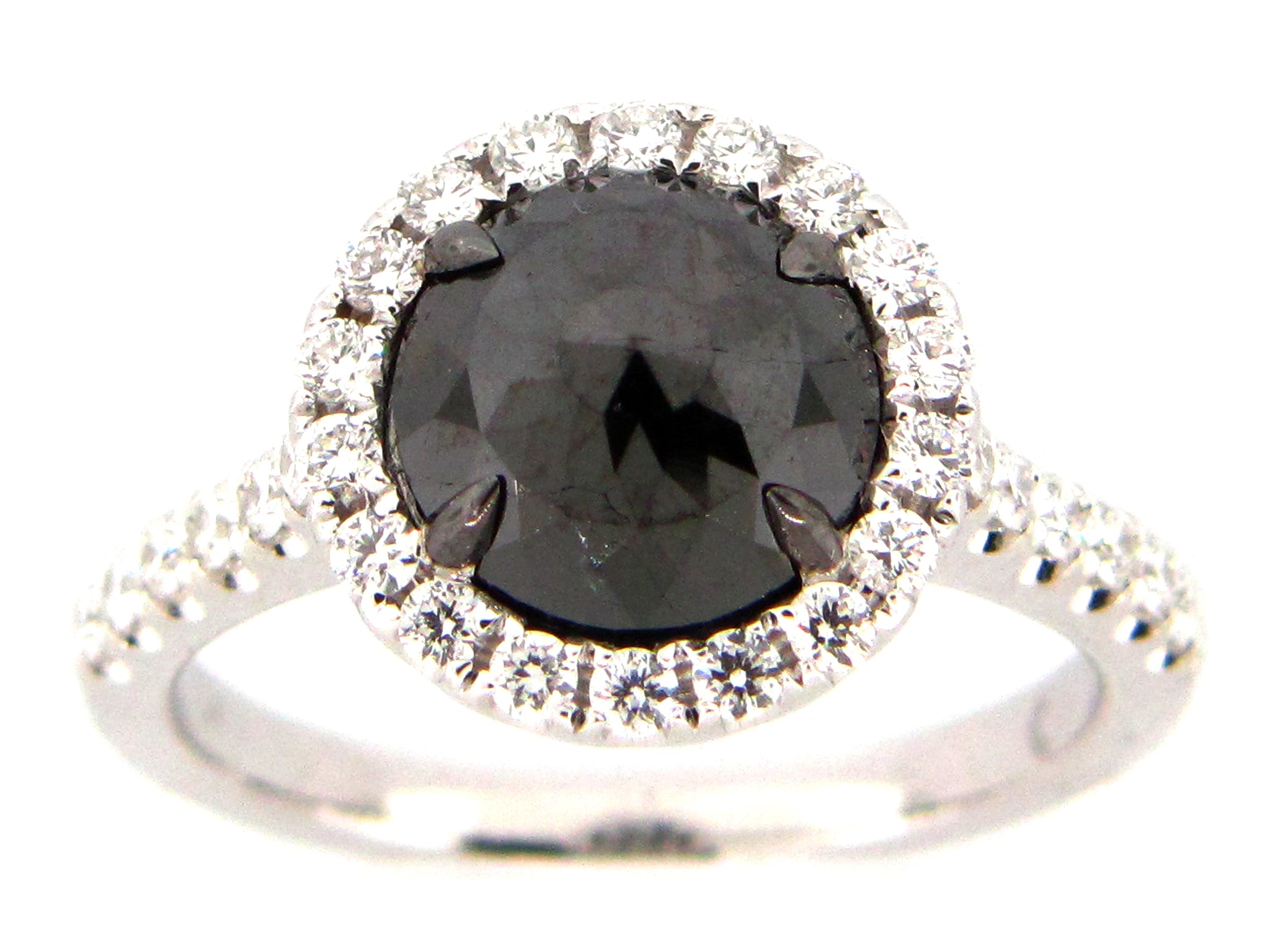 A ring featuring a large black diamond round stone surrounded by smaller diamonds